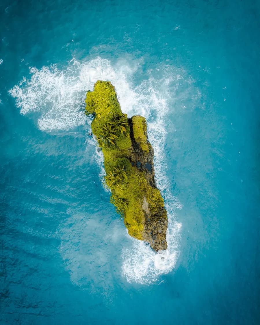 Rock formation rising out of open ocean